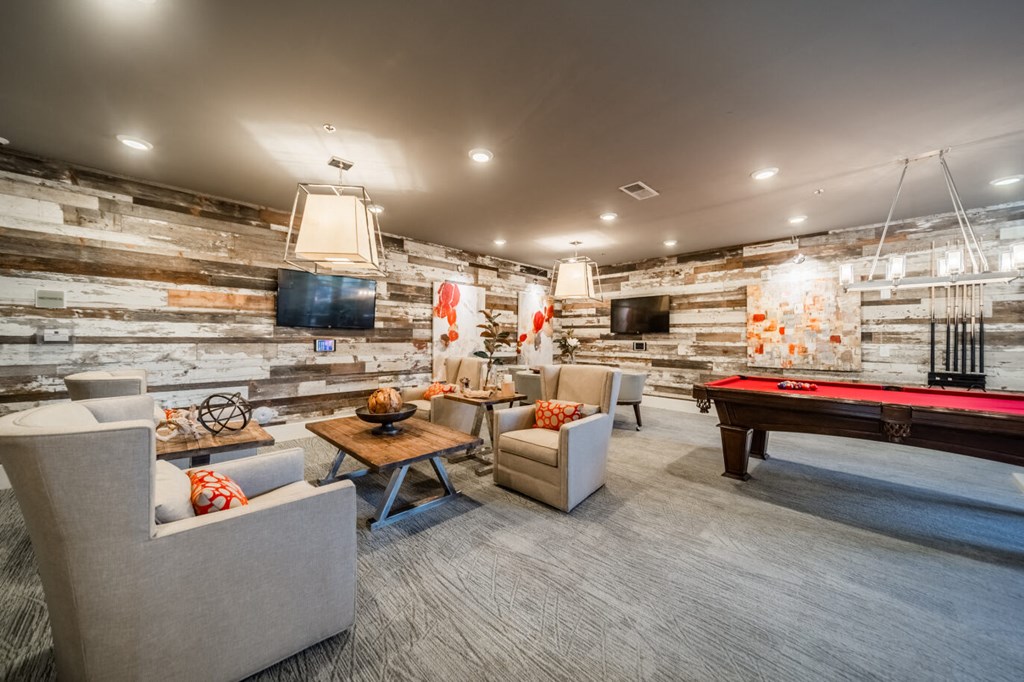 a game room with a pool table and couches