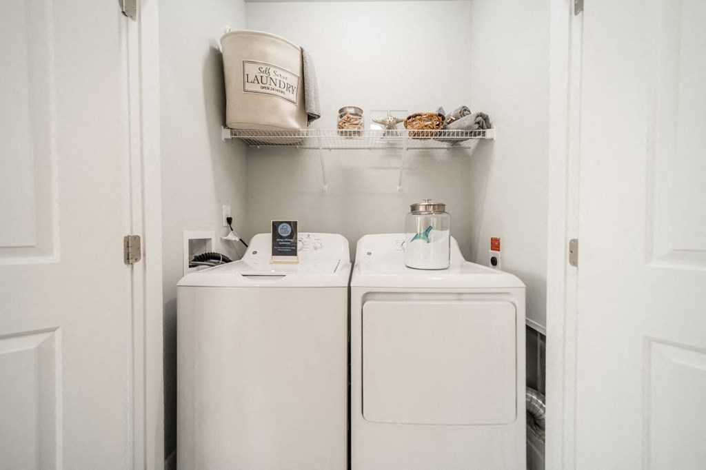 a small laundry room with a washer and dryer and a sink
