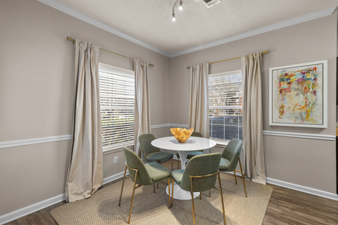 A dining room with a table and chairs at Heights at New Garden apartments in Greensboro, NC.