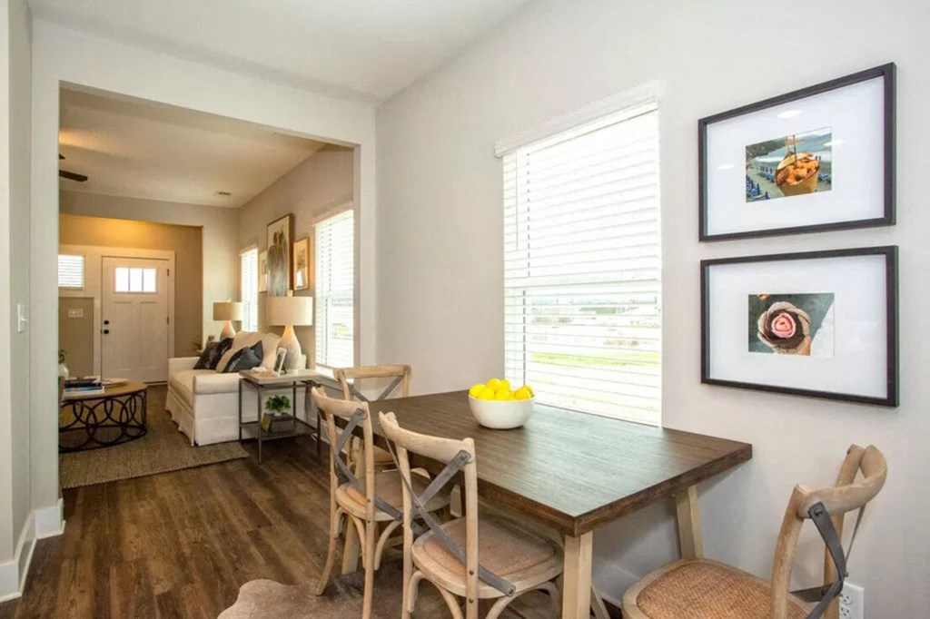 a dining room and living room with a table and chairs