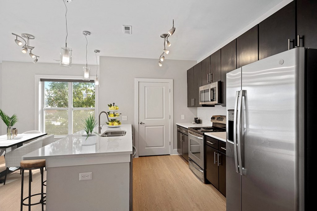 an open kitchen with stainless steel appliances and a large window