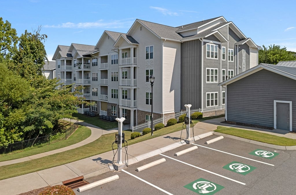an empty parking lot in front of an apartment building