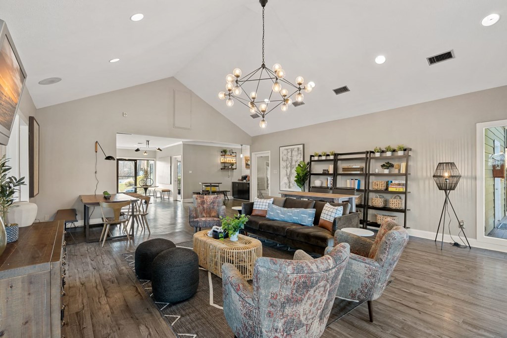 a living room filled with furniture and a chandelier