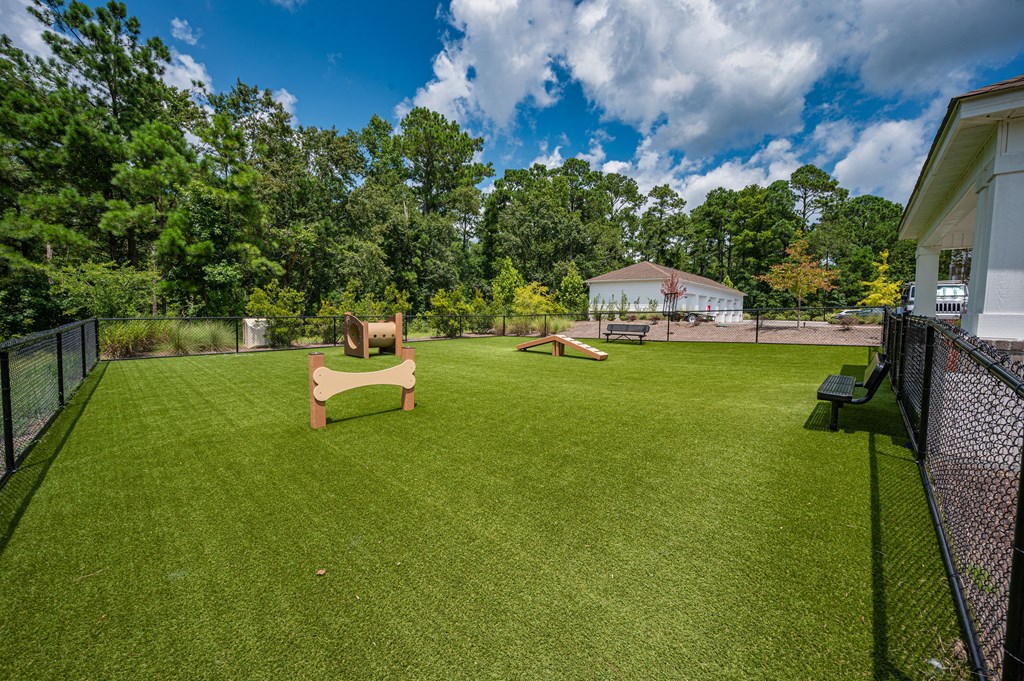 A dog park with a dog house and a dog bed.