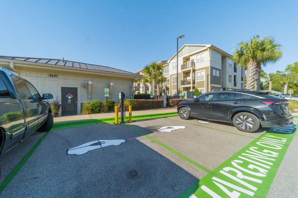a parking lot with cars parked in front of a building