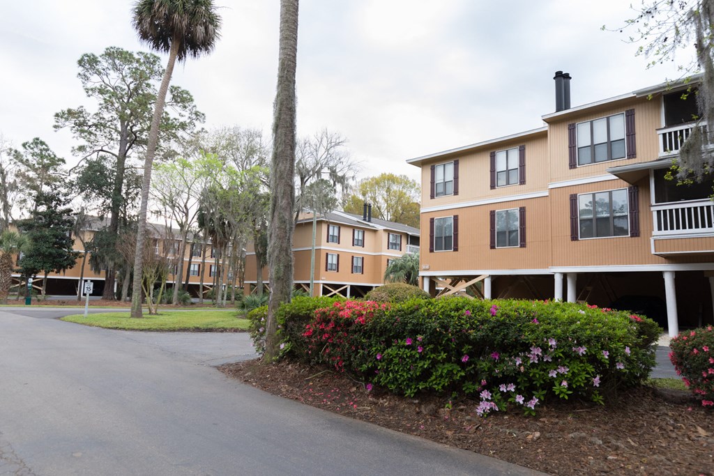 a row of apartment buildings on the side of a road