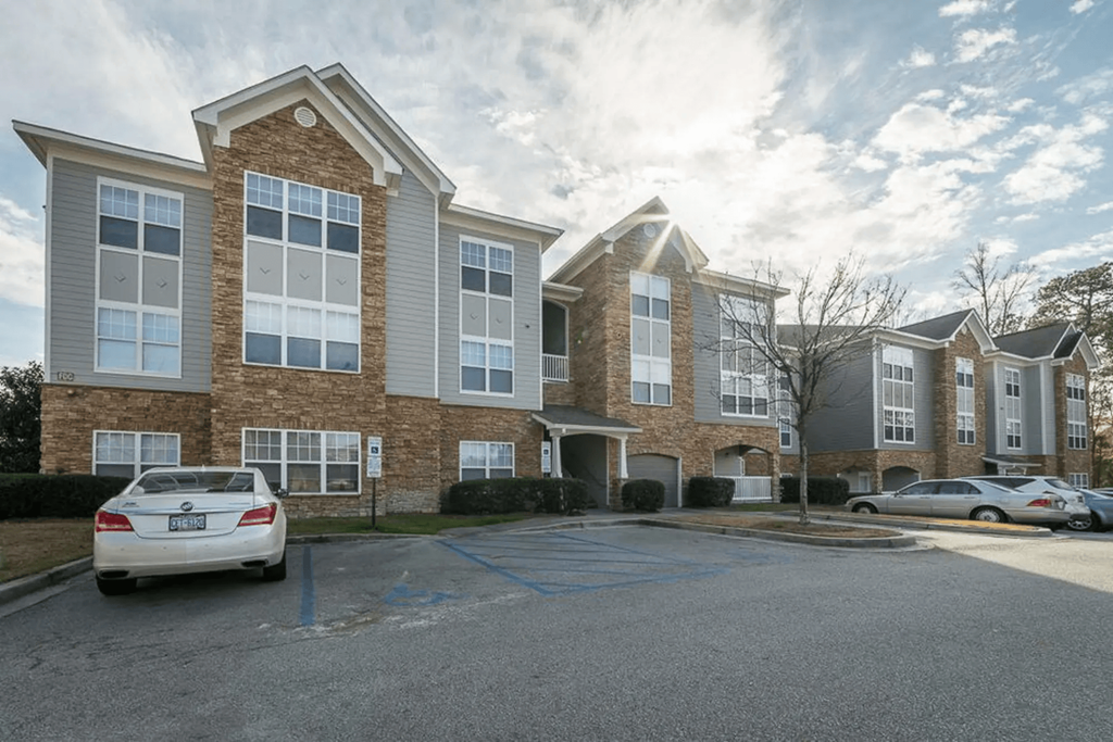 a parking lot in front of an apartment building