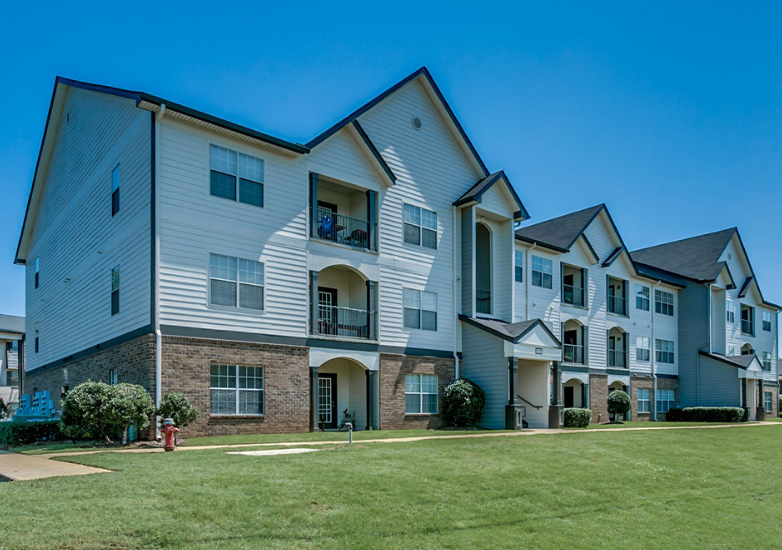 a row of houses with a grass yard