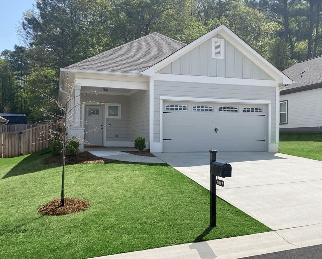 a white house with a driveway and a parking meter