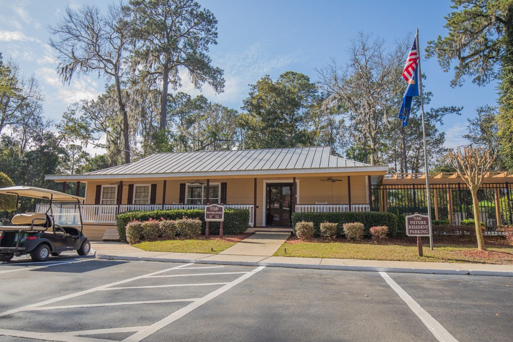 a yellow building with an flag and a golf cart in front of it
