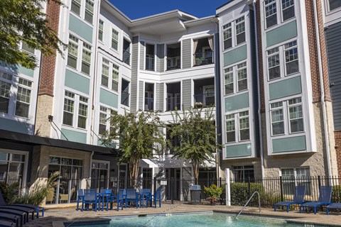 A large building with a pool in front.