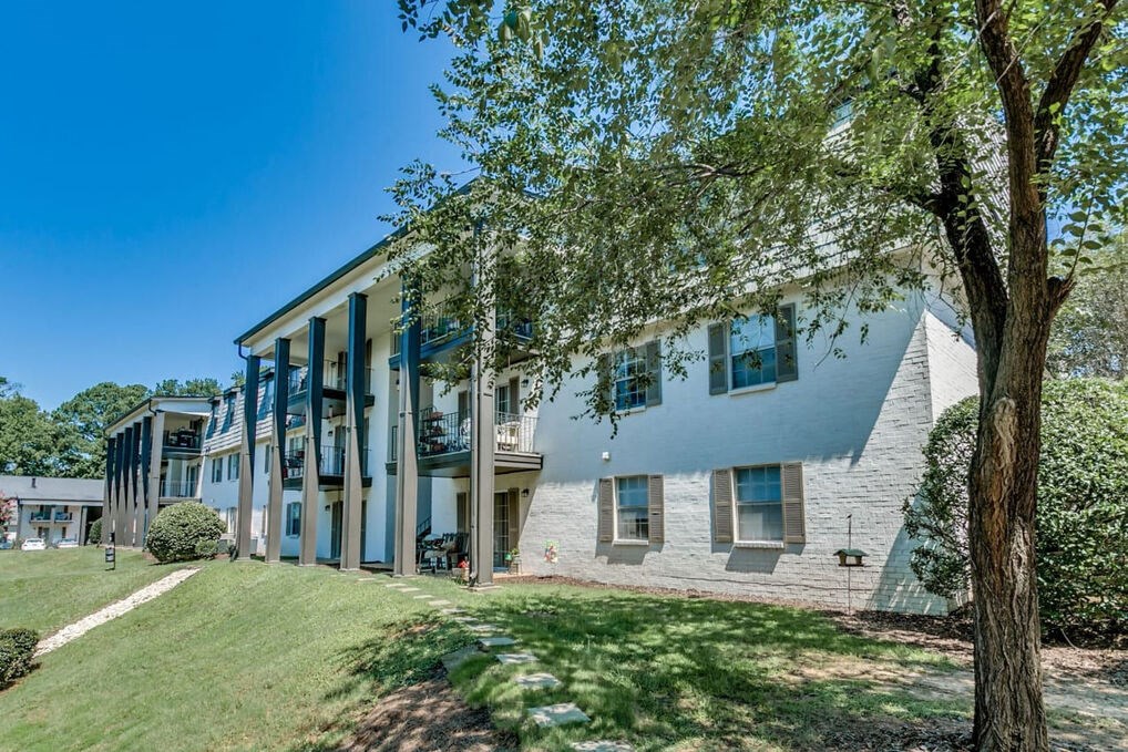 a large white house with a tree in front of it