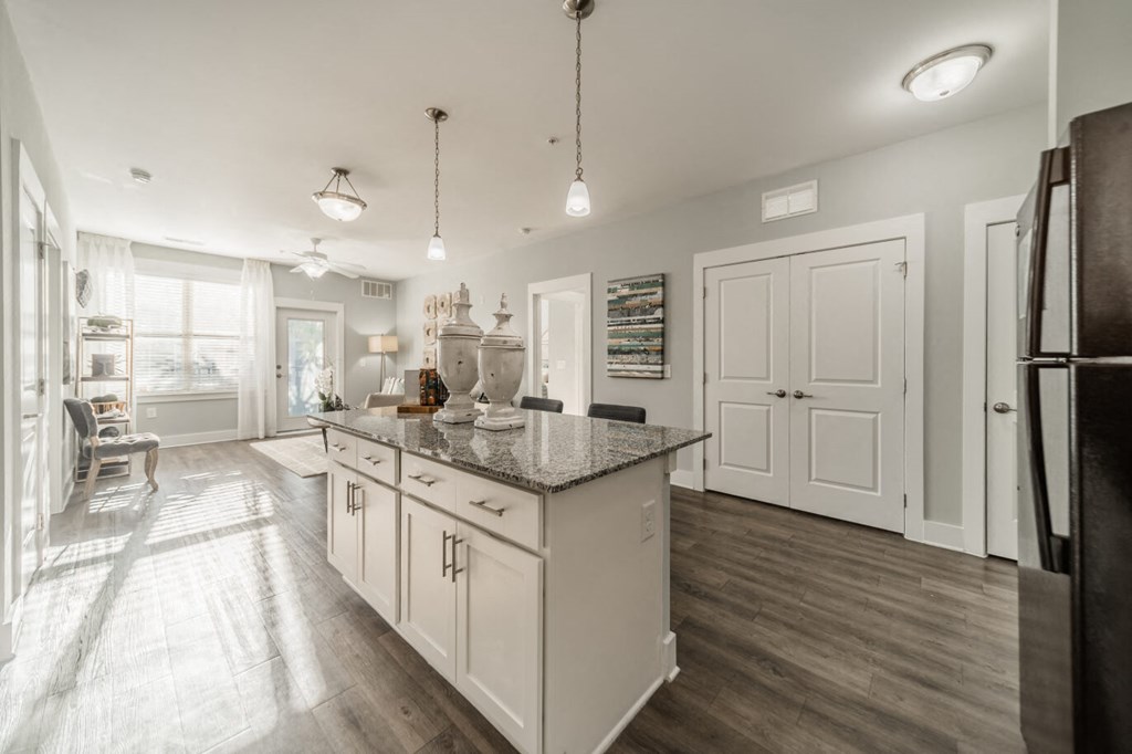 a kitchen with white cabinets and a counter top