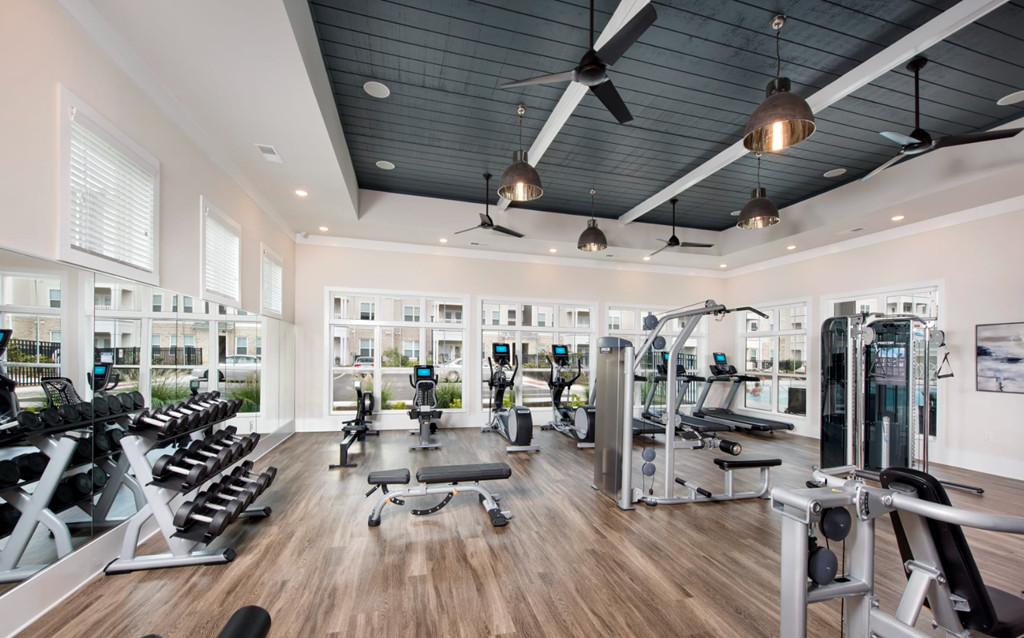 a gym with a black ceiling and wood flooring