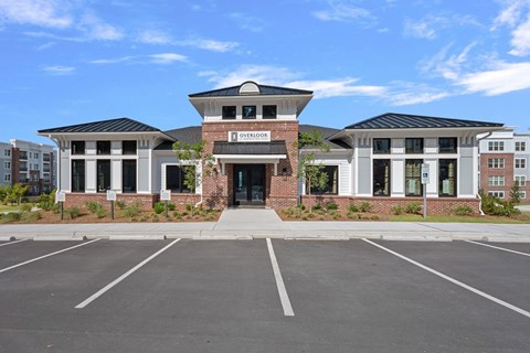 The image shows a building with the name "Overlook" on it, surrounded by a parking lot.