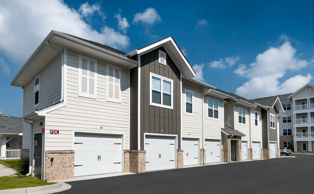 a building with white doors and a street in front of it