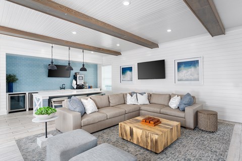 A modern living room with a grey sofa and a wooden coffee table.