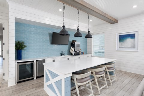 A kitchen with a white counter and blue tiles.