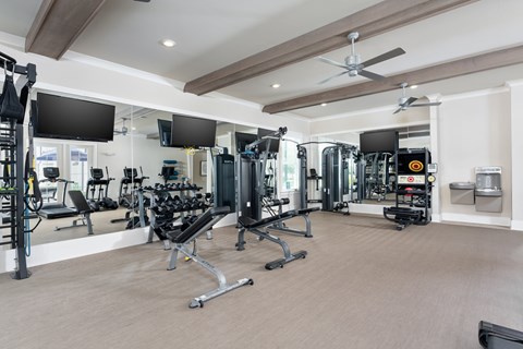 A spacious gym with a variety of equipment.