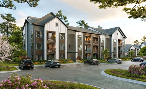 A modern building with a parking lot in front of it.