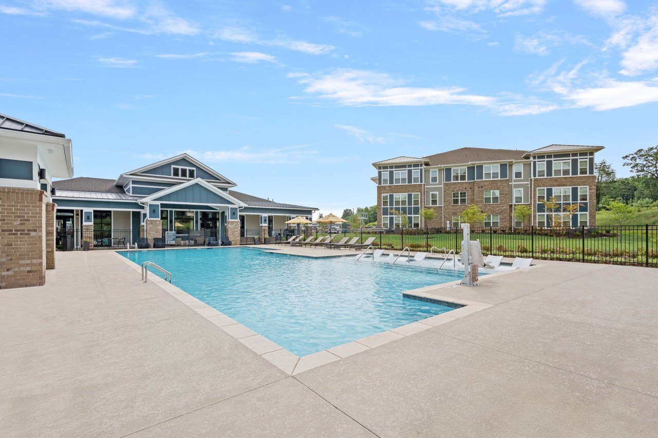 A large swimming pool in front of a building.