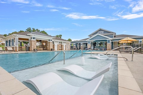 A large outdoor swimming pool with a slide.