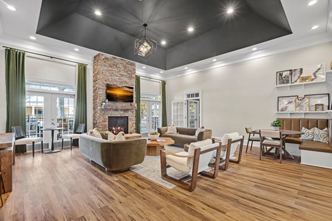 A modern living room with a fireplace and a large couch.