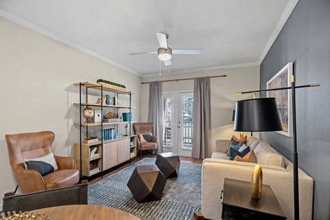 A living room with a brown leather chair and a wooden coffee table.