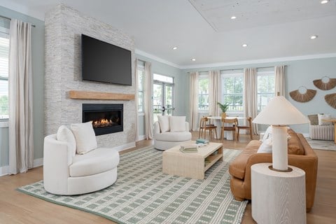 A living room with a fireplace and a television above it.