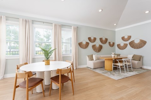 A dining room with a white table and chairs.