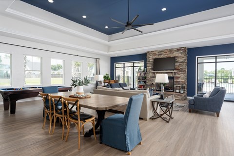 A living room with a pool table and a fireplace.
