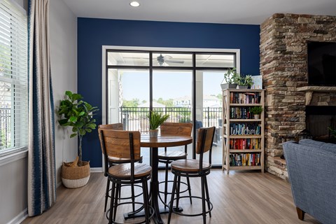 A dining room with a table and chairs.