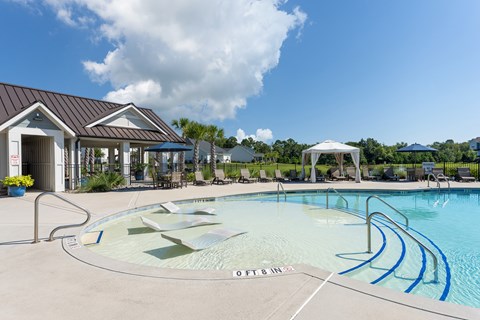 A swimming pool with a building in the background.