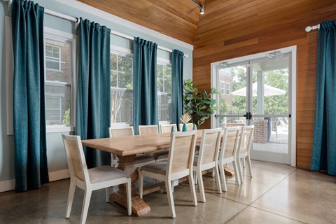 A dining room with a wooden table and chairs.