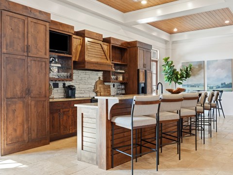 A kitchen with wooden cabinets and a stone countertop.