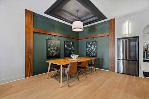 A dining room with a wooden table and chairs.