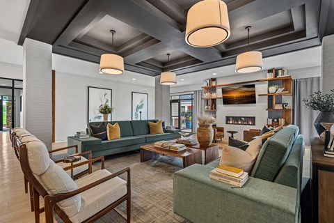 A living room with a green couch and a fireplace.