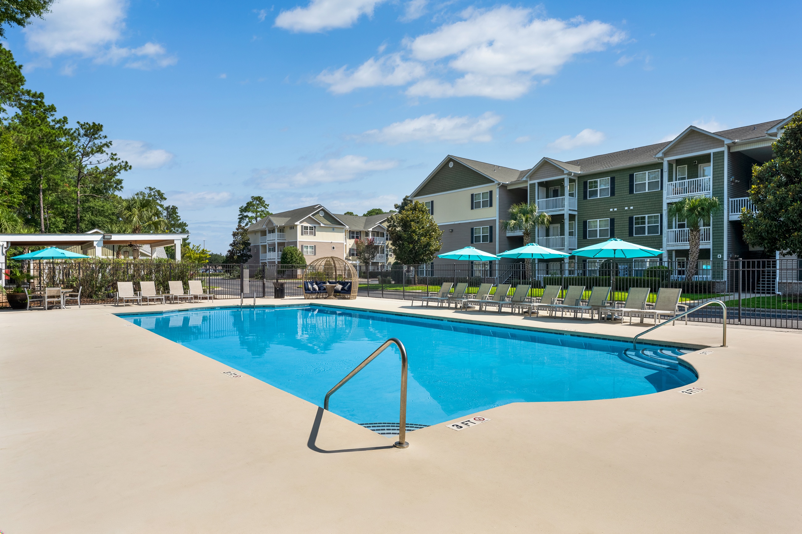 A large swimming pool with a diving board in the middle of it.
