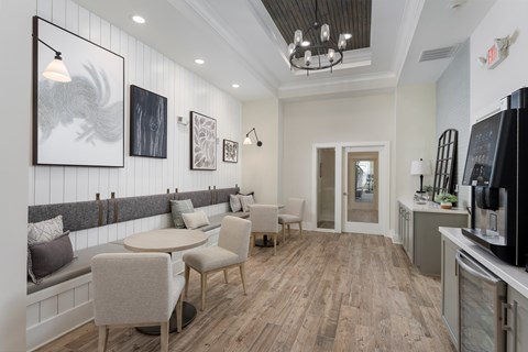 A modern kitchen with a dining table and chairs.