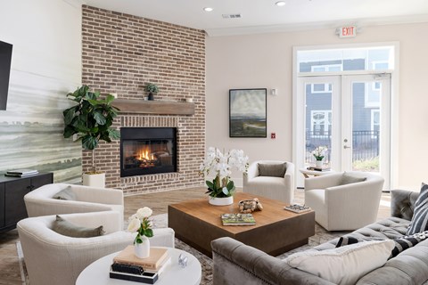 A living room with a fireplace and a painting on the wall.