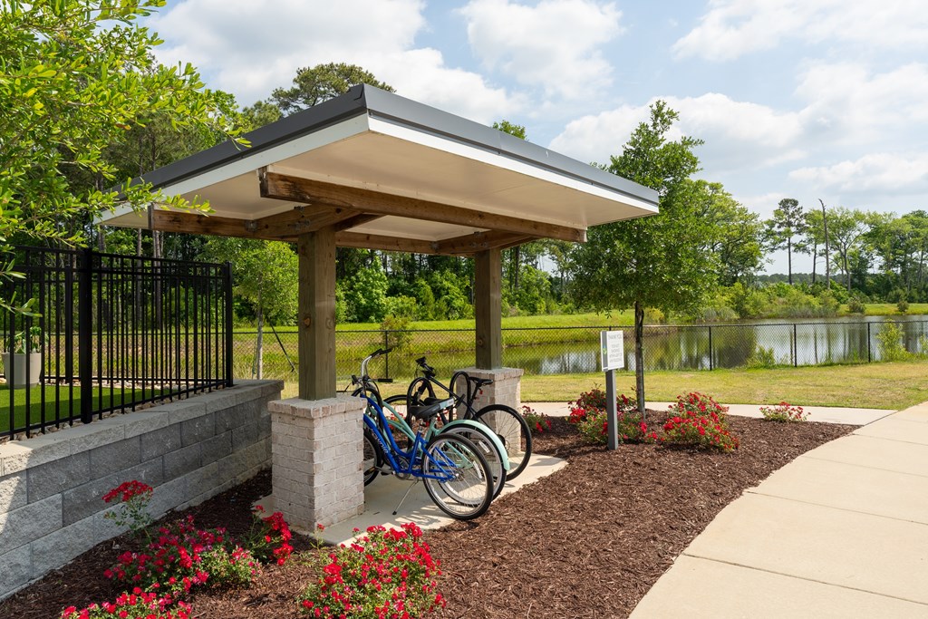 A bike is parked under a shelter in a park.
