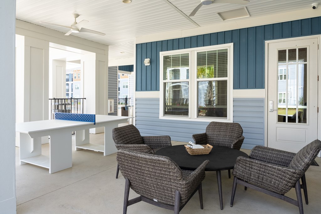 A patio with a table and chairs.