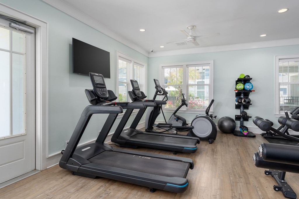 A home gym with treadmills and other exercise equipment.