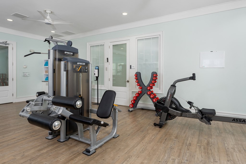 A home gym with a stationary bike and a multi-functional machine.