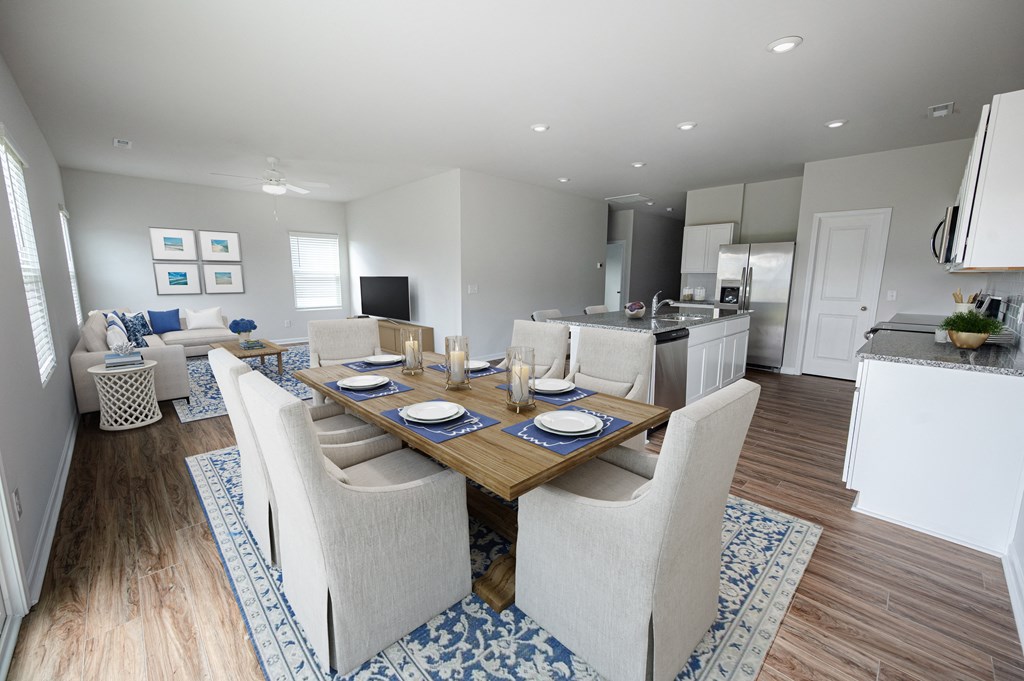 a dining room and living room with a table and chairs