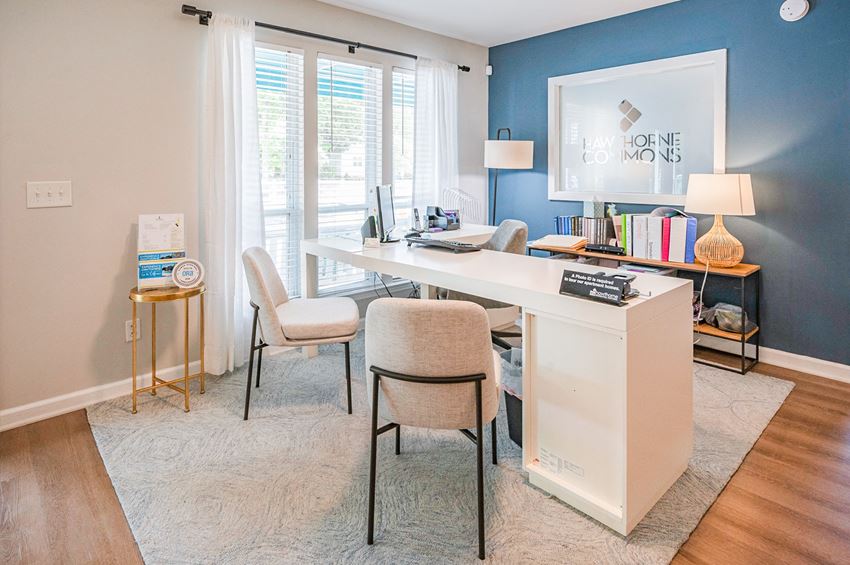 a home office with a blue accent wall and a white desk with two chairs - Photo Gallery