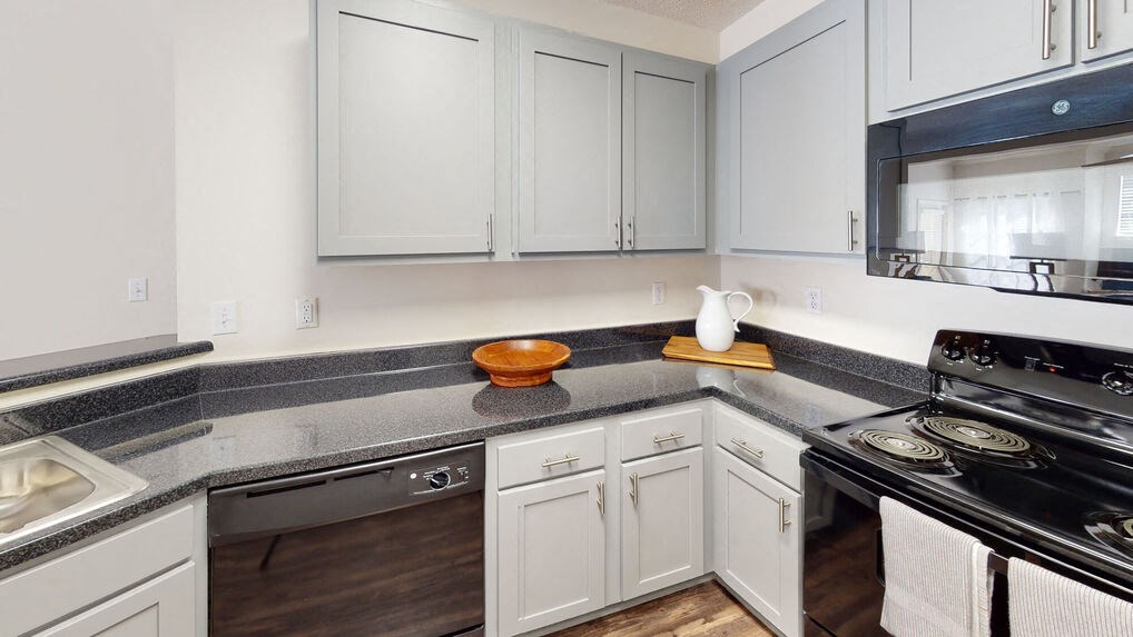 a kitchen with white cabinets and a counter top