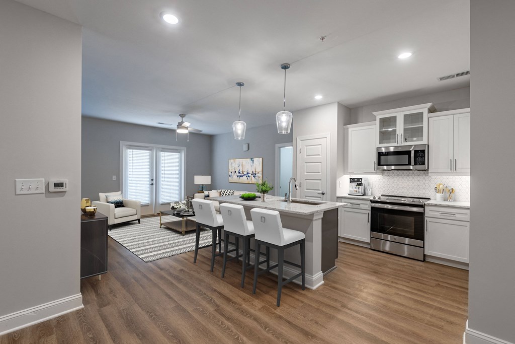 an open kitchen and living room with a dining room table and chairs