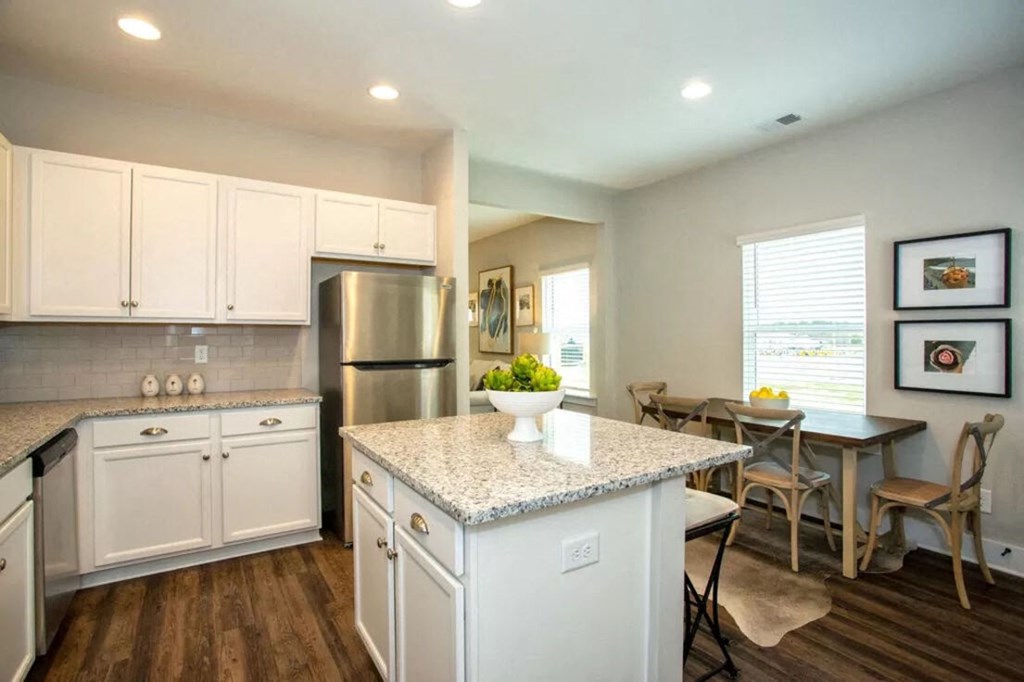 a kitchen with white cabinets and a counter top