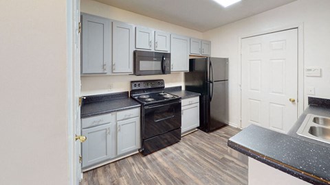 a kitchen with stainless steel appliances and white cabinets